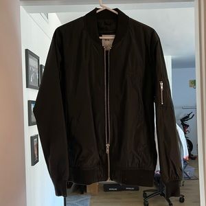 Bird rides bomber jacket